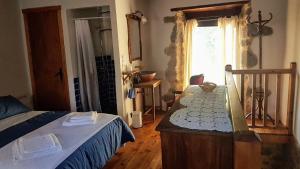 a bedroom with a bed and a window at Casas Quo Vadis -Azul in Lugo