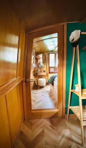 a small room with a door to a bedroom at The Four Sisters Boatel - Houseboat in Edinburgh