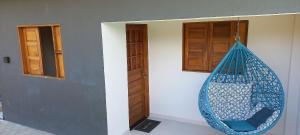 a blue hammock hanging from a wall in a room at Flats da Ilha 2 Quartos in Marechal Deodoro