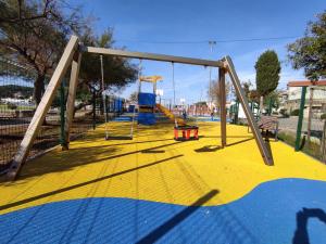 an empty playground with a swing set in a park at Kuća za odmor Marina in Sutomišćica