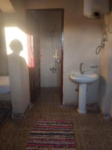 a bathroom with a sink and a toilet in a room at Oum House in Siwa
