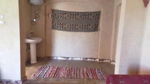 a bathroom with a sink and a shower curtain at Oum House in Siwa