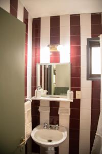 a bathroom with a sink and a mirror at Hostería Las Rosas in Esquel