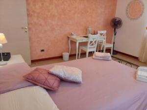 a bedroom with a table and a bed with pillows at Italy's enchanting ambiance - A snug apartment in Rome in Rome