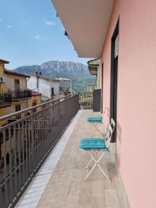 a balcony with two chairs and a view of mountains at Casa di Mamma in Godrano