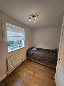 a bedroom with a bed and a window at Stylish 2 Bedroom Semi-Detached House in Leicester in Leicester