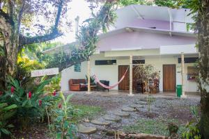 a house with a hammock in front of it at Puerto Viejo Club, Villa & pool for 6 pax in Puerto Viejo