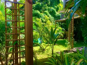 a wooden trellis in a garden with plants at Ti Kay Ilets in Les Trois-Îlets