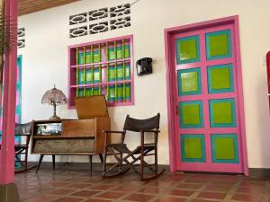 a room with colorful doors and a desk and chairs at Casa de los Colores in Honda