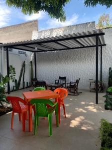 a patio with colorful tables and chairs under a canopy at Casa de los Colores in Honda