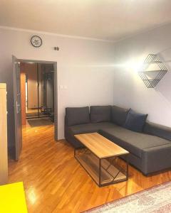 a living room with a couch and a table at Metro Bemowo Comfort Apartment in Warsaw
