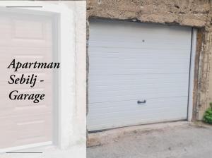 a white garage door with the words apartment security garage at Apartman Bazar in Sarajevo