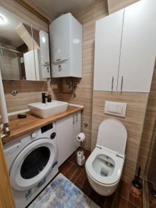 a small bathroom with a toilet and a sink at Apartman Bazar in Sarajevo