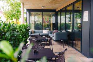 a patio with tables and chairs in a restaurant at Roomreich in Ingolstadt