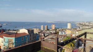 a view of a city with the ocean and buildings at Hotel Cabernet in Valparaíso