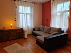a living room with a couch and a large window at Cosy studio near Aqva Spa in Rakvere