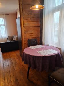 a dining room with a table and a couch at Cosy studio near Aqva Spa in Rakvere