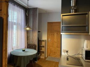 a small kitchen with a table in a room at Cosy studio near Aqva Spa in Rakvere