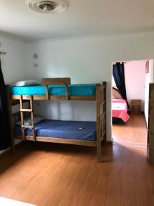 a room with two bunk beds in a room at Hostel S & J Mendoza in Guaymallen
