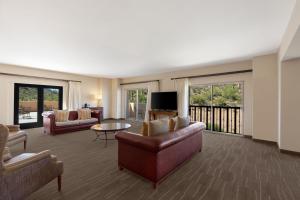 a living room with a couch and chairs and a television at JW Marriott Tucson Starr Pass Resort in Tucson