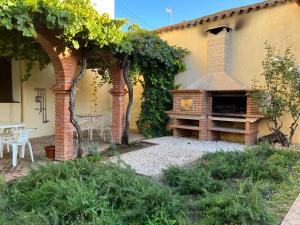 a patio with a brick oven in a yard at La Casa de Andújar in Cubas +6 photos