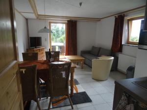 a kitchen and living room with a table and chairs at Landhaus Bonaventura in Millstatt