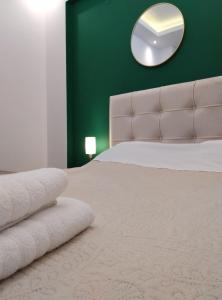 a bedroom with a large bed and a mirror at Domus Apartment - City Center in Veria