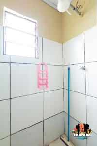 a bathroom with a shower and a window at Hostel Chapada Dos Guimarães in Chapada dos Guimarães