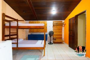 a room with two bunk beds and a fan at Hostel Chapada Dos Guimarães in Chapada dos Guimarães