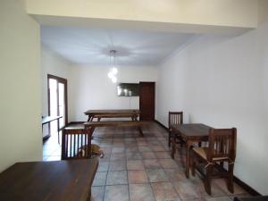 a dining room with two tables and chairs in it at Hostel Terminal in Barraquero