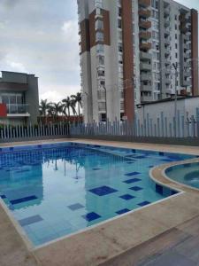 a large swimming pool in front of some buildings at Apartamento nuevo, central, hermosa vista. in Dosquebradas