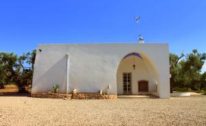 a small white building with a large doorway at Country Salenthouse in Marina di Mancaversa