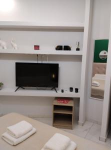 a living room with a flat screen tv on a wall at Domus Apartment - City Center in Veria