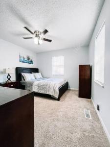 a bedroom with a bed and a ceiling fan at Welcome to Risa! 