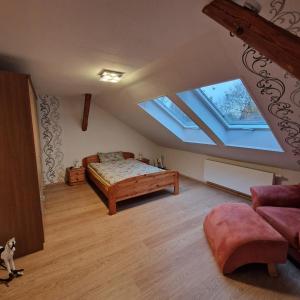 a bedroom with a bed and two skylights at Bei Conny und Bernd in Barnstorf