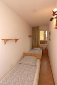 two beds in a small room with a window at Ferienwohnung L417 für 2-4 Personen an der Ostsee in Schönberg in Holstein