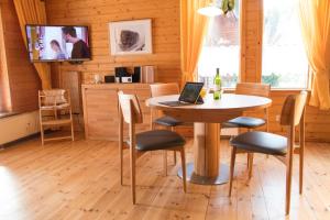 a dining room with a table with a laptop on it at Ferienhaus 08 Blauvogel in Hasselfelde
