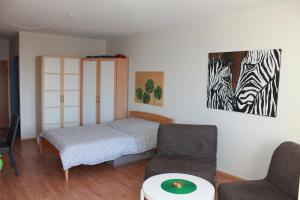 a bedroom with a bed and two zebras on the wall at Ferienappartement K111 für 2-4 Personen in Strandnähe in Schönberg in Holstein