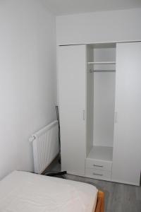 a bedroom with a bed and a closet at Ferienwohnung Ostsee F414 in Schönberg in Holstein