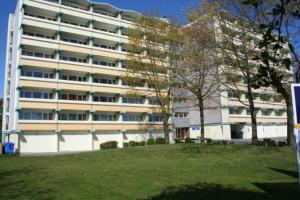 a large white building with trees in front of it at Ferienwohnung E510 für 2-4 Personen an der Ostsee in Brasilien