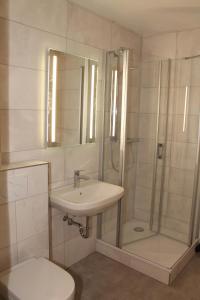 a bathroom with a sink and a shower and a toilet at Ferienwohnung F237 für 2-4 Personen an der Ostsee in Brasilien