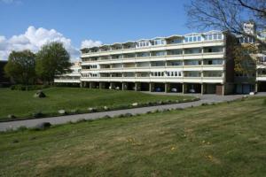 a large building with a grass field in front of it at Ferienappartement S136 für 2-4 Personen an der Ostsee in Brasilien