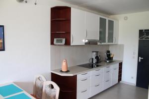 a kitchen with white cabinets and a counter top at Ferienappartement S136 für 2-4 Personen an der Ostsee in Brasilien
