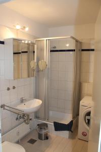 a bathroom with a sink and a shower and a toilet at Ferienappartement S136 für 2-4 Personen an der Ostsee in Brasilien