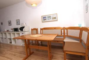 a dining room with a wooden table and chairs at Ferienwohnung F156 für 2-4 Personen an der Ostsee in Brasilien