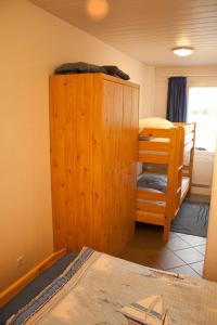 een slaapkamer met een stapelbed en een houten kast bij Ferienwohnung F127 an der Ostsee in Brasilien