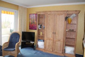 um quarto com um grande armário de madeira e uma televisão em Ostsee-Studio F356 em Brasilien