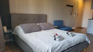 a bedroom with a large bed with towels on it at Apartament pod Dębowcem - Starzyńskiego Valley in Bielsko-Biala