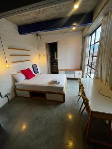 1 dormitorio con cama, escritorio y mesa en Indie Studio, en Medellín