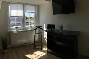 a room with a black desk and a window at Seeblick 2 in Dahme